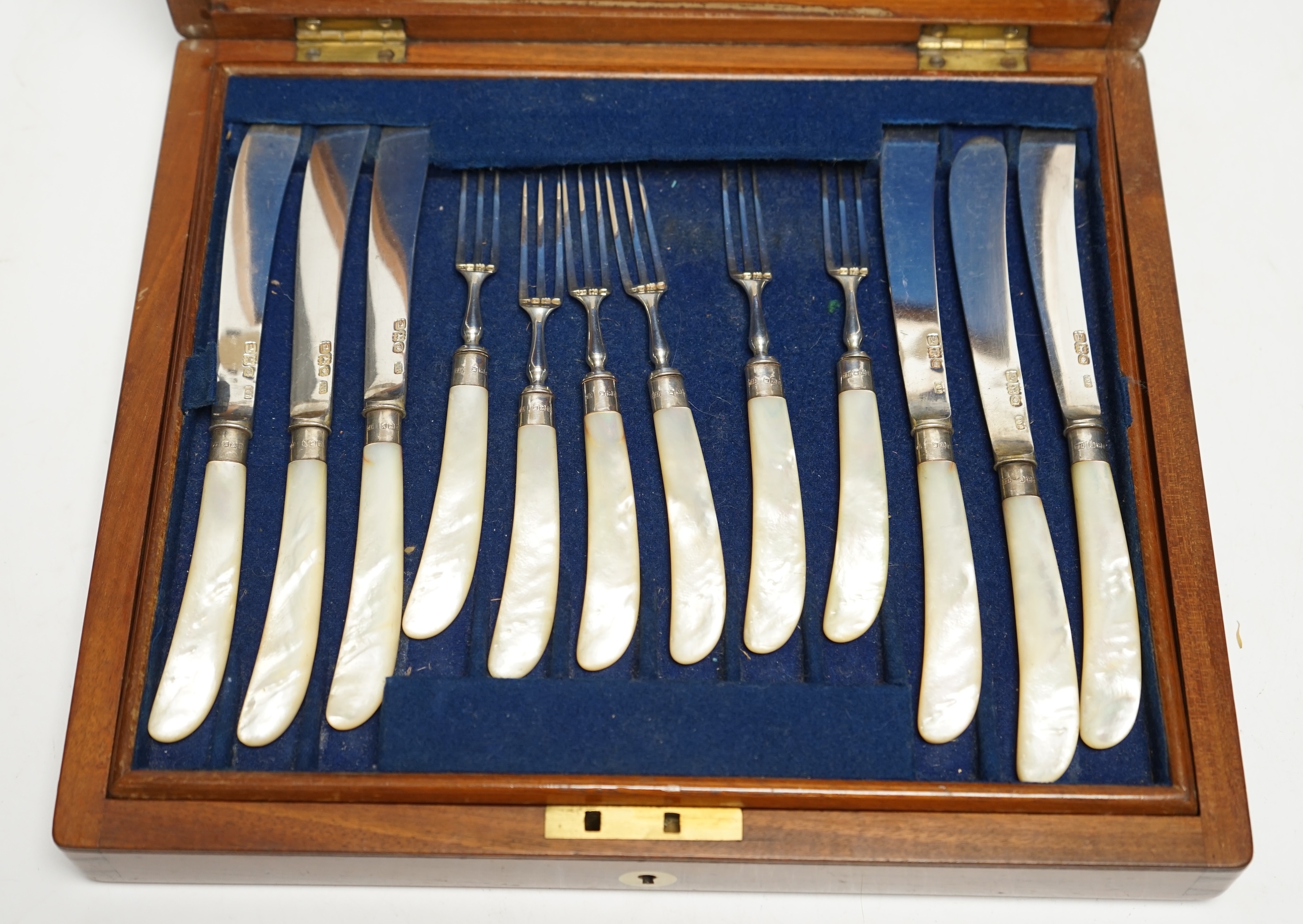 A set of twelve pairs of late Victorian mother of pearl pistol handled silver dessert eaters, by Levesley Brothers, London, 1899, in associated case. Condition - poor